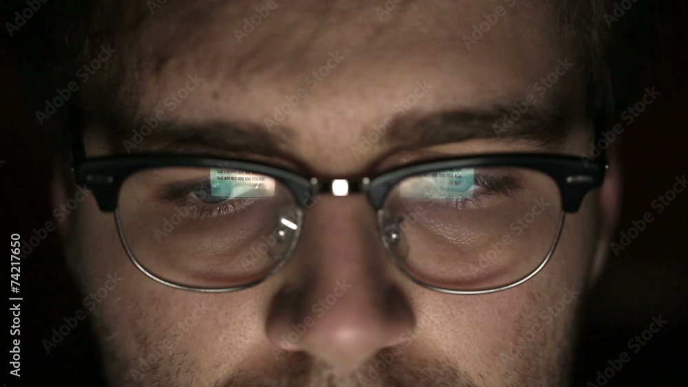 Portrait of a young man with glasses who works at night. Portrait of a young man with glasses who works at night.