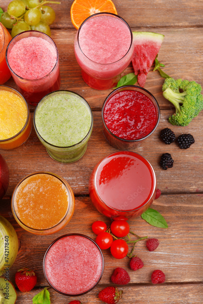 Glasses of tasty fresh juice, on wooden table. Glasses of tasty fresh juice, on wooden table.