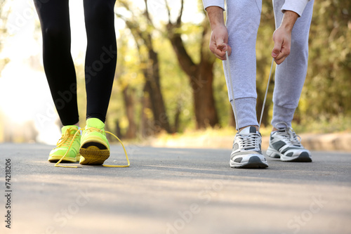 Runner feet on road, outdoors