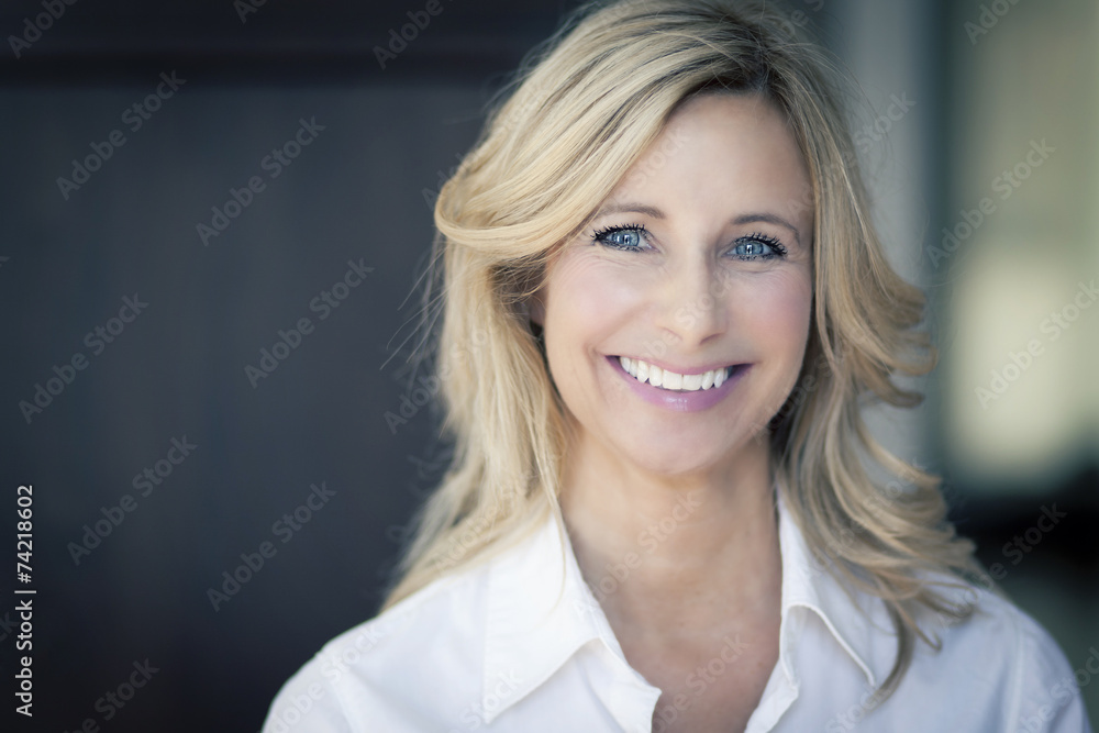 Mature woman smiling at the camera Mature woman smiling at the camera
