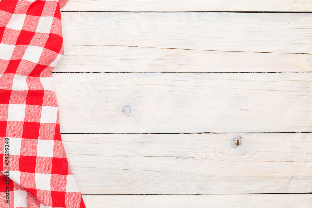 Red towel over wooden kitchen table Red towel over wooden kitchen table