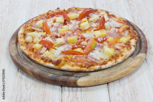 Hawaiian Pizza on wood table