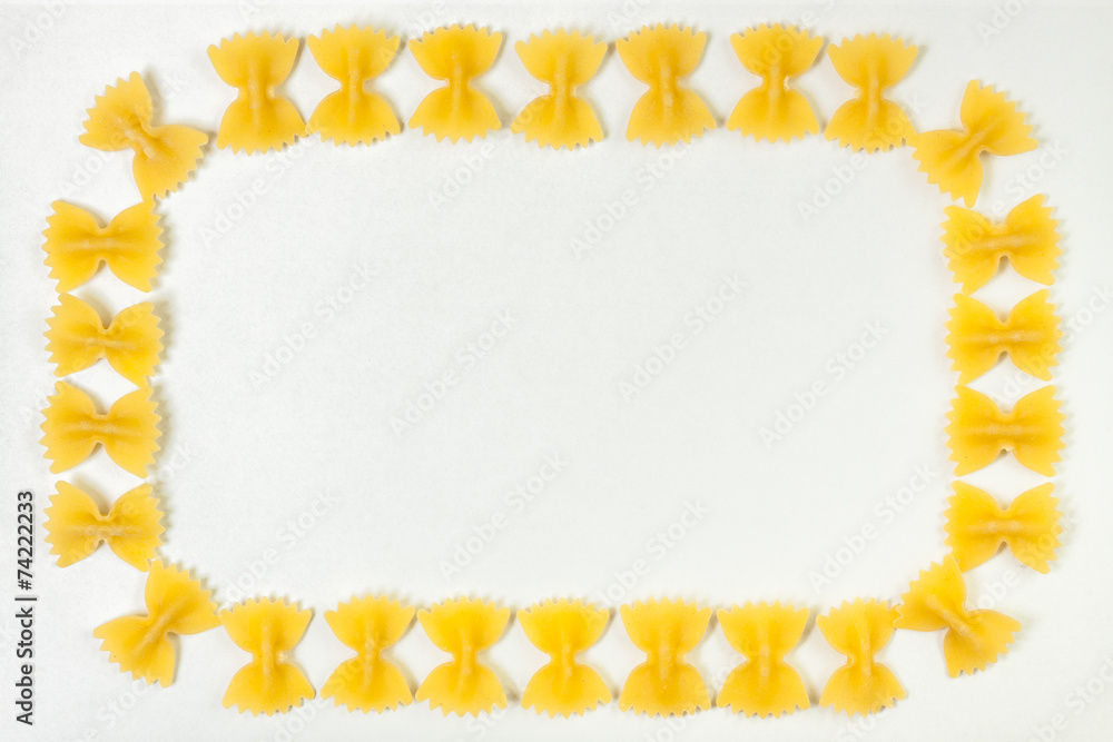 Raw farfalle pasta frame isolated on white background Raw farfalle pasta frame isolated on white background