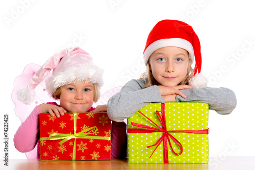 two girls girl with Santa- cap and presents