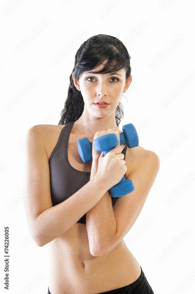 Young attractive girl exercising with pair of dumbbells Young attractive girl exercising with pair of dumbbells