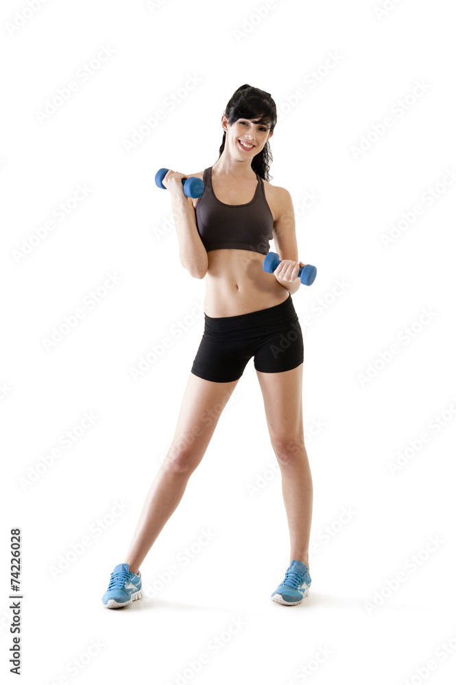 Young woman exercising with dumbbells isolated on white Young woman exercising with dumbbells isolated on white