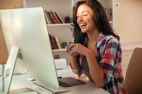 Attractive female talking with her friends online. photo