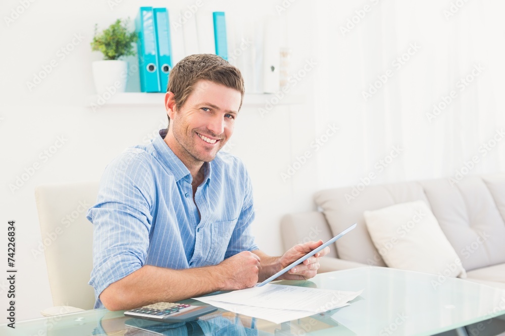 Casual businessman using tablet at desk Casual businessman using tablet at desk