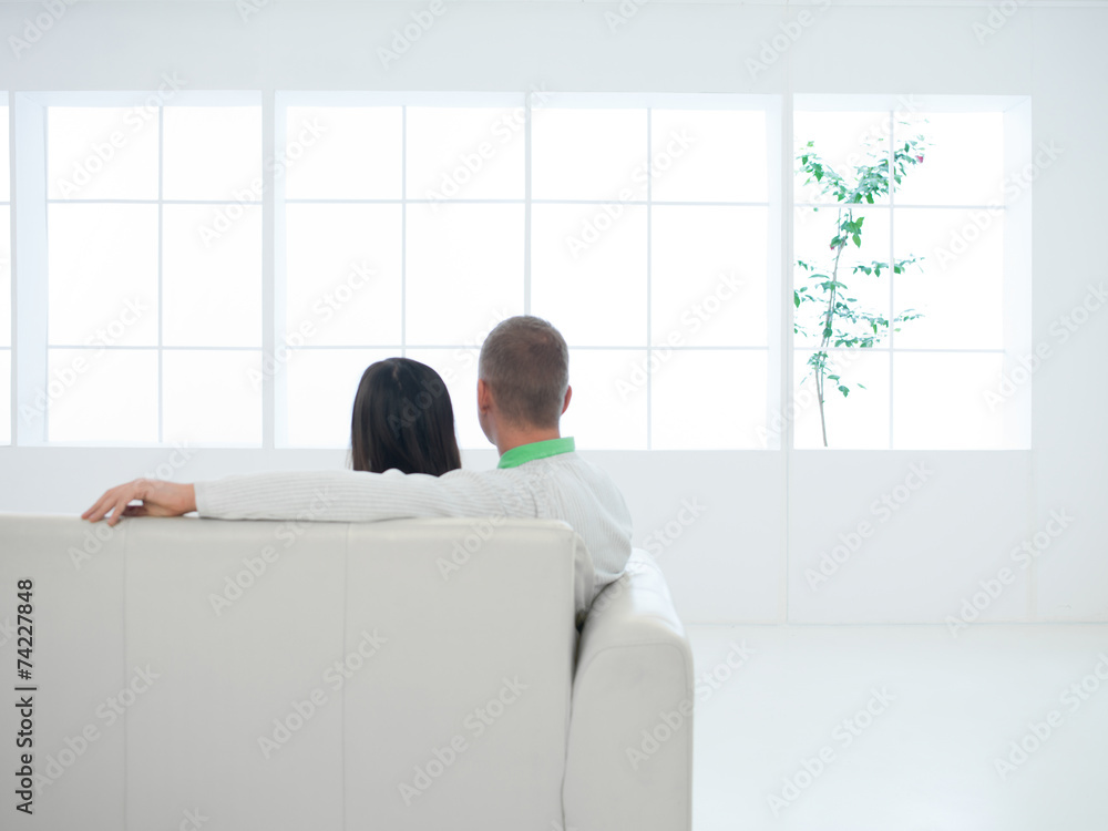 couple enjoying the view sitting on couch couple enjoying the view sitting on couch