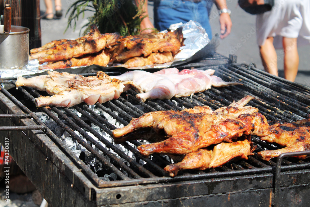 chicken portions on smoking grill, street food