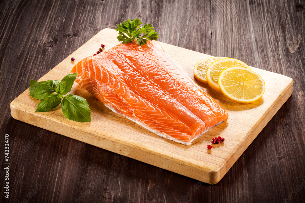 Fresh raw salmon fillet on cutting board Fresh raw salmon fillet on cutting board