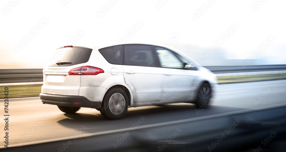 Blured car riding on high-speed road Blured car riding on high-speed road