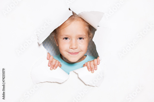 Child looking out of a hole in paper