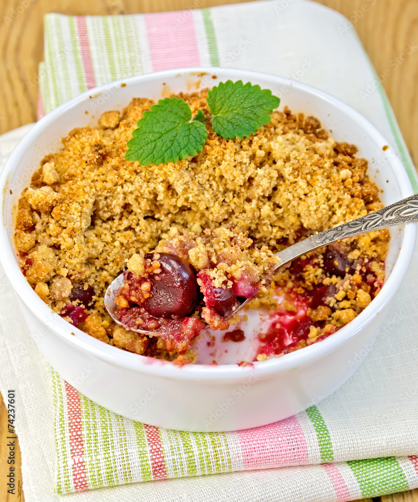 Crumble cherry in bowl with spoon on napkin Crumble cherry in bowl with spoon on napkin