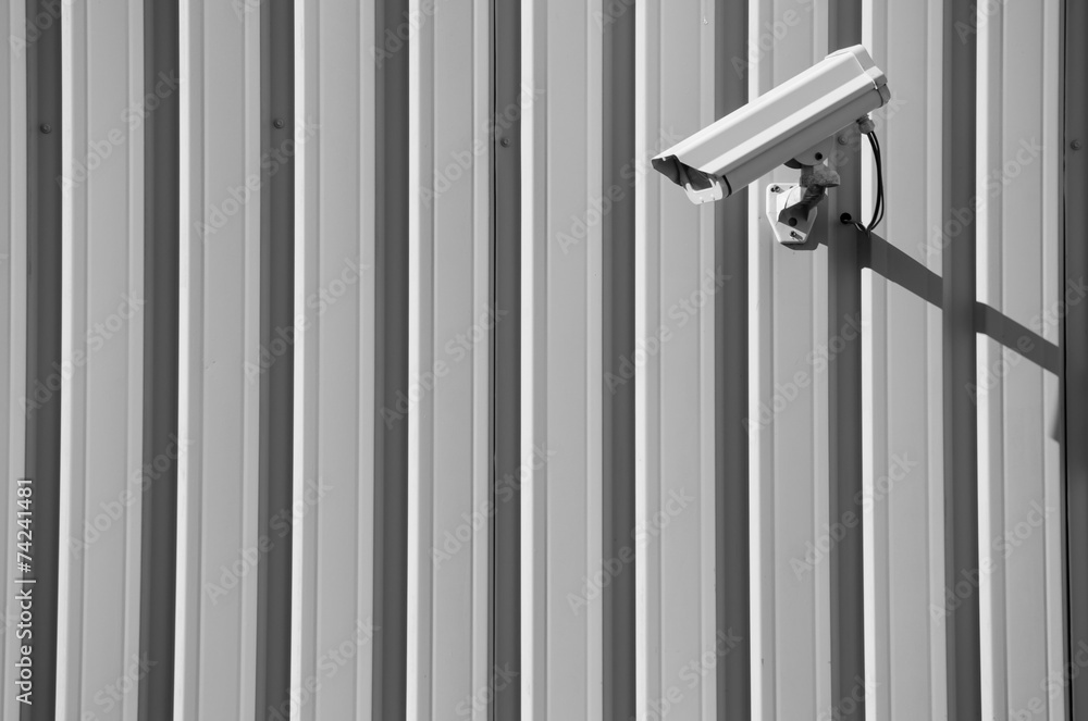 Black and White of Security Camera on Plain Wall Black and White of Security Camera on Plain Wall