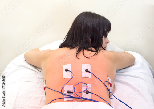 woman in massage clinic makes electropulse photo