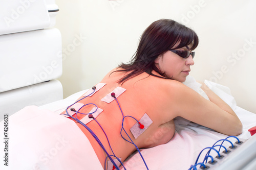 woman in massage clinic makes electropulse photo