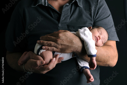 Newborn baby and his father's hand photo