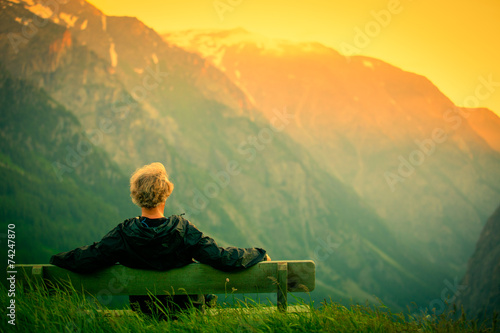 man on bench in French Alps © Pearl Media