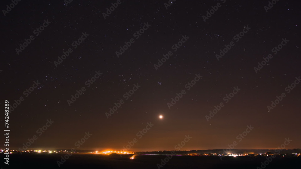 The night sky - stars and moon above the city lights The night sky - stars and moon above the city lights