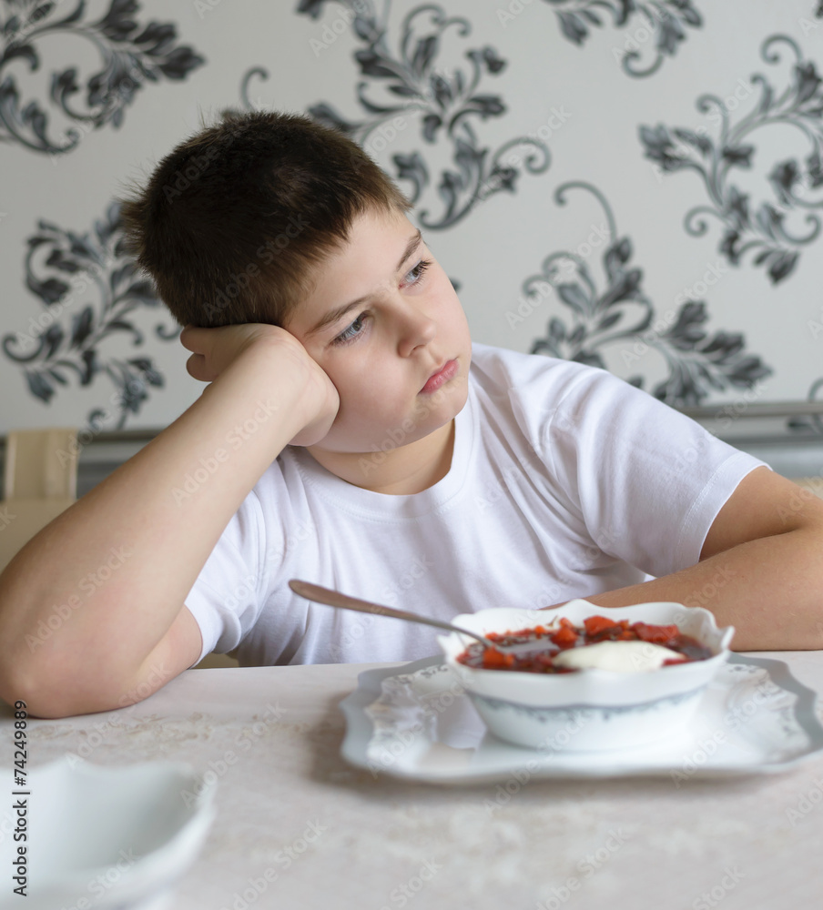 Teenager boy do not want to eat soup Teenager boy do not want to eat soup