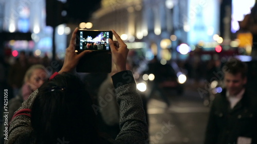 Person Taking a Picture with a Smartphone of Piccadilly Traffic and Street Scene  photo