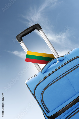 Destination Lithuania. Blue suitcase with flag.