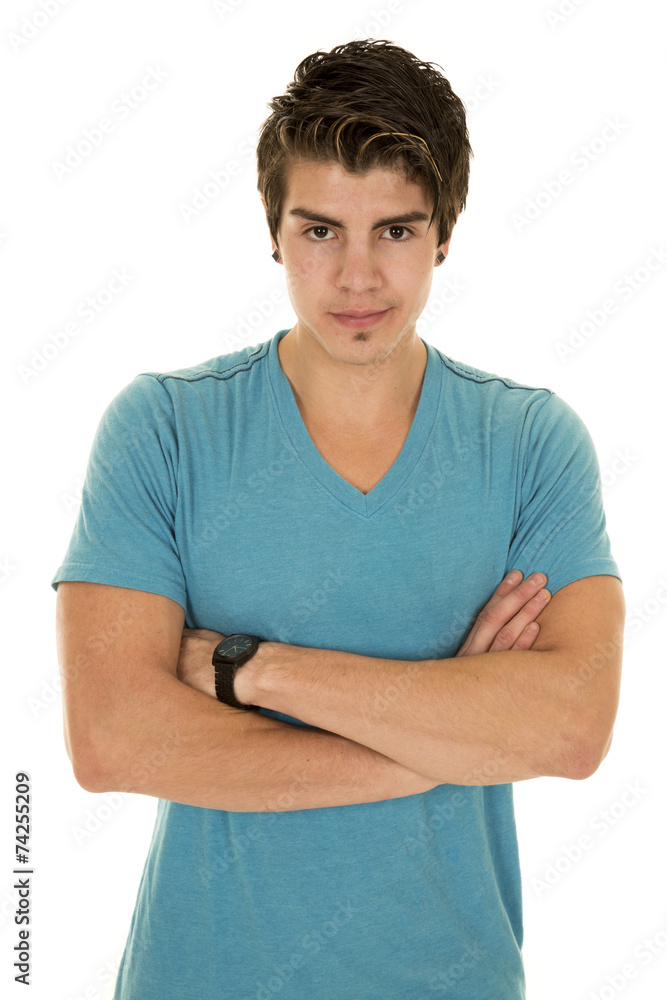 man in a blue shirt looking with arms folded man in a blue shirt looking with arms folded