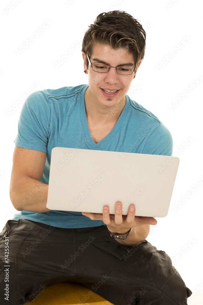 man in blue shirt holding a laptop man in blue shirt holding a laptop
