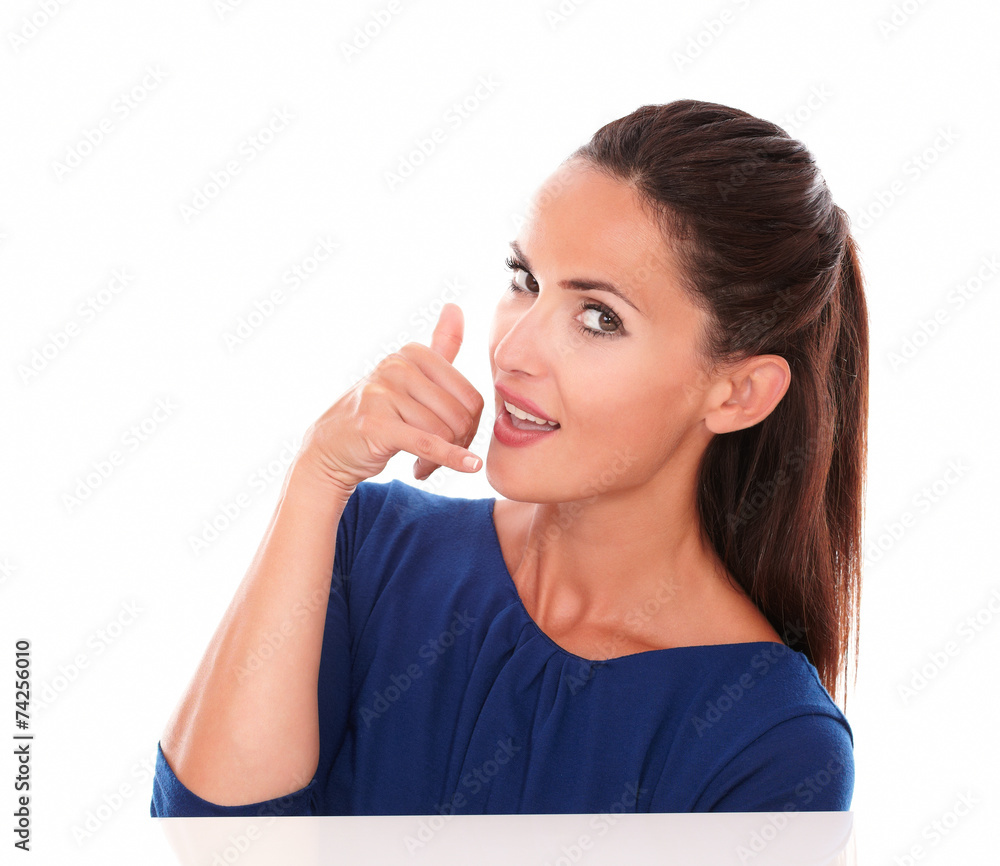 Lovely lady in blue blouse gesturing a call Lovely lady in blue blouse gesturing a call