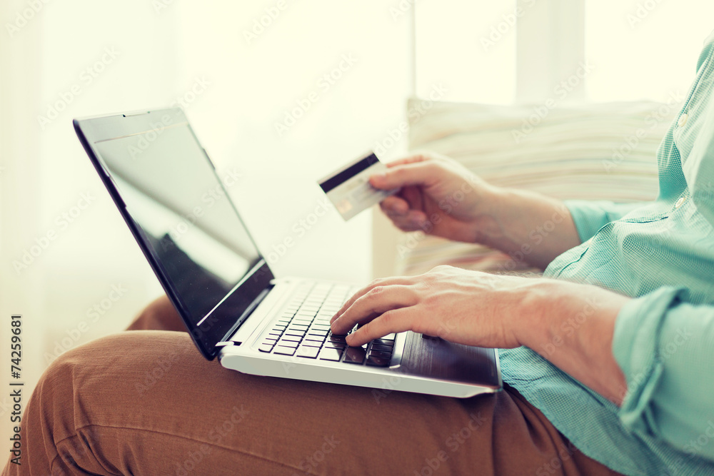 close up of man with laptop and credit card close up of man with laptop and credit card