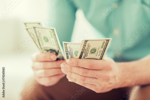 close up of man counting money at home