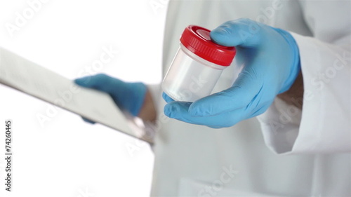 Doctor Turns With Urine Sample Cup