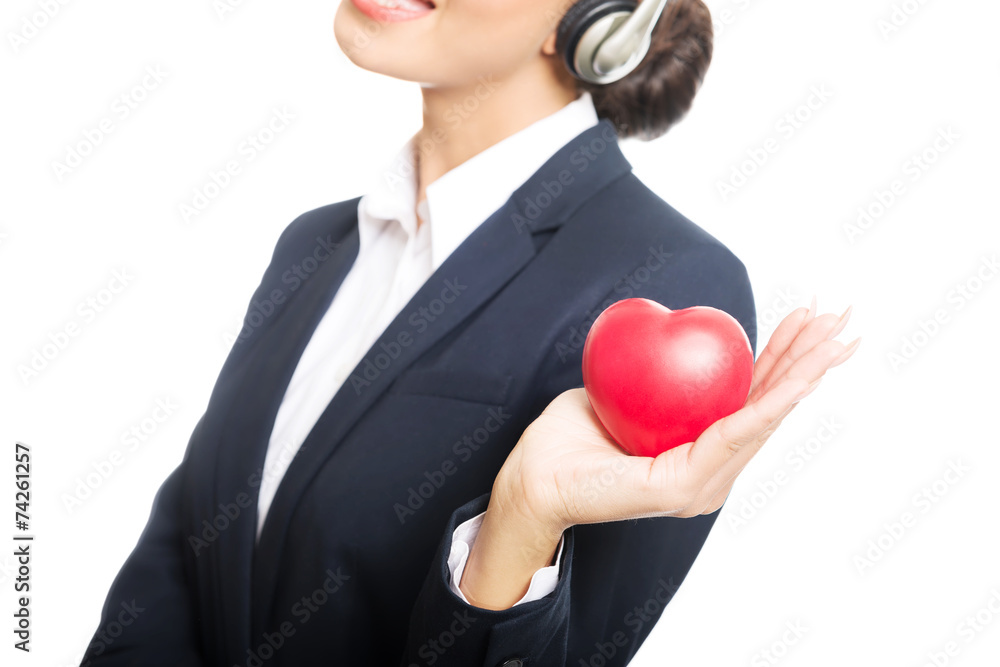 Young call center woman holding heart model Young call center woman holding heart model
