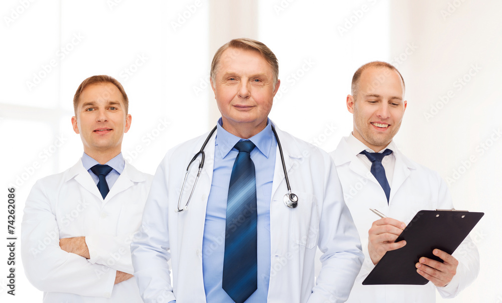 group of smiling male doctors in white coats group of smiling male doctors in white coats