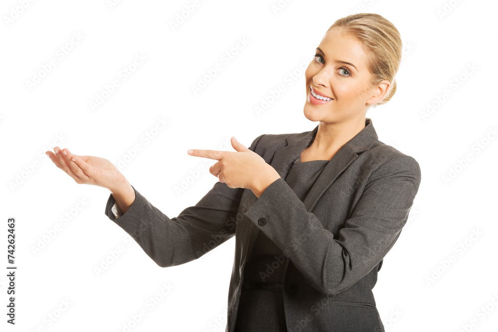 Business woman showing copy space on the left Business woman showing copy space on the left