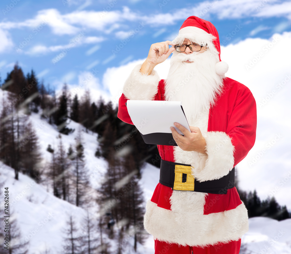 man in costume of santa claus with notepad man in costume of santa claus with notepad