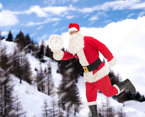 man in costume of santa claus with clock © Syda Productions