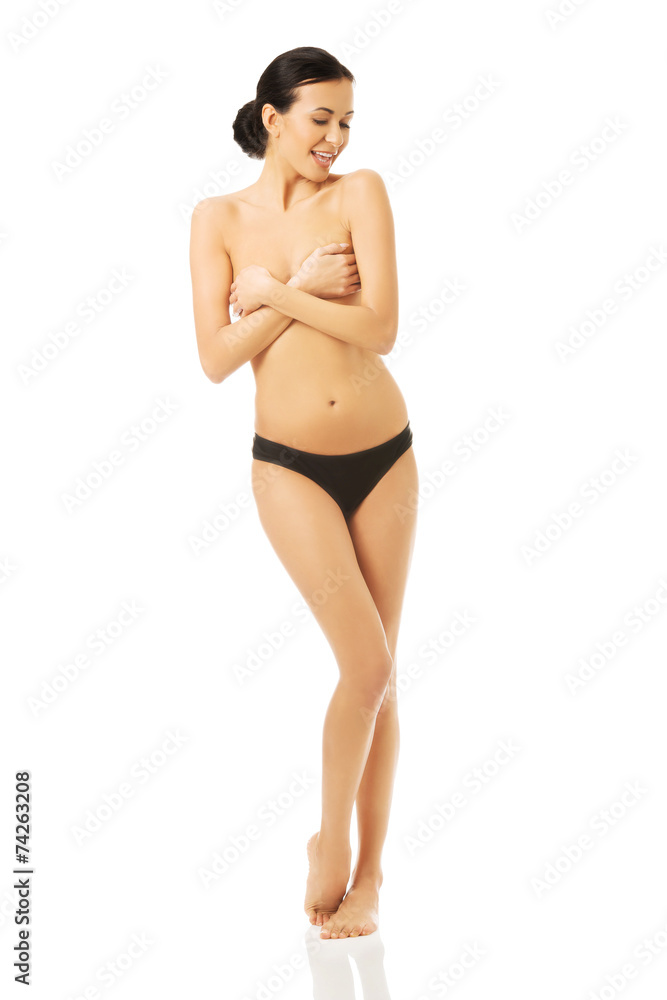 Obraz premium Nude woman standing, covering her breast