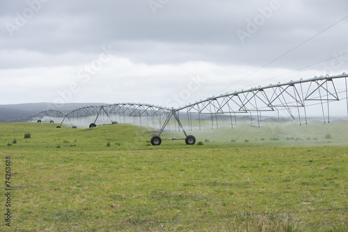 Irrigation by Pivot sprinkler on grass field © roboriginal