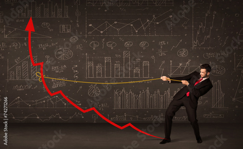Businessman pulling a red arrow upright with a rope