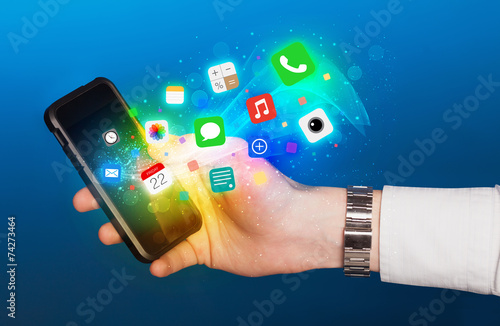 Hand holding smartphone with colorful app icons