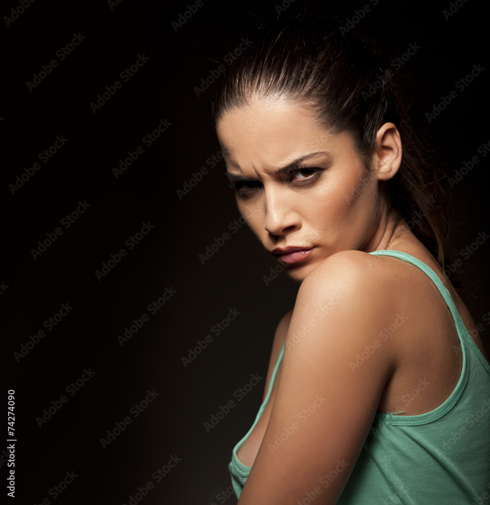portrait of beautiful angry woman on a dark background portrait of beautiful angry woman on a dark background