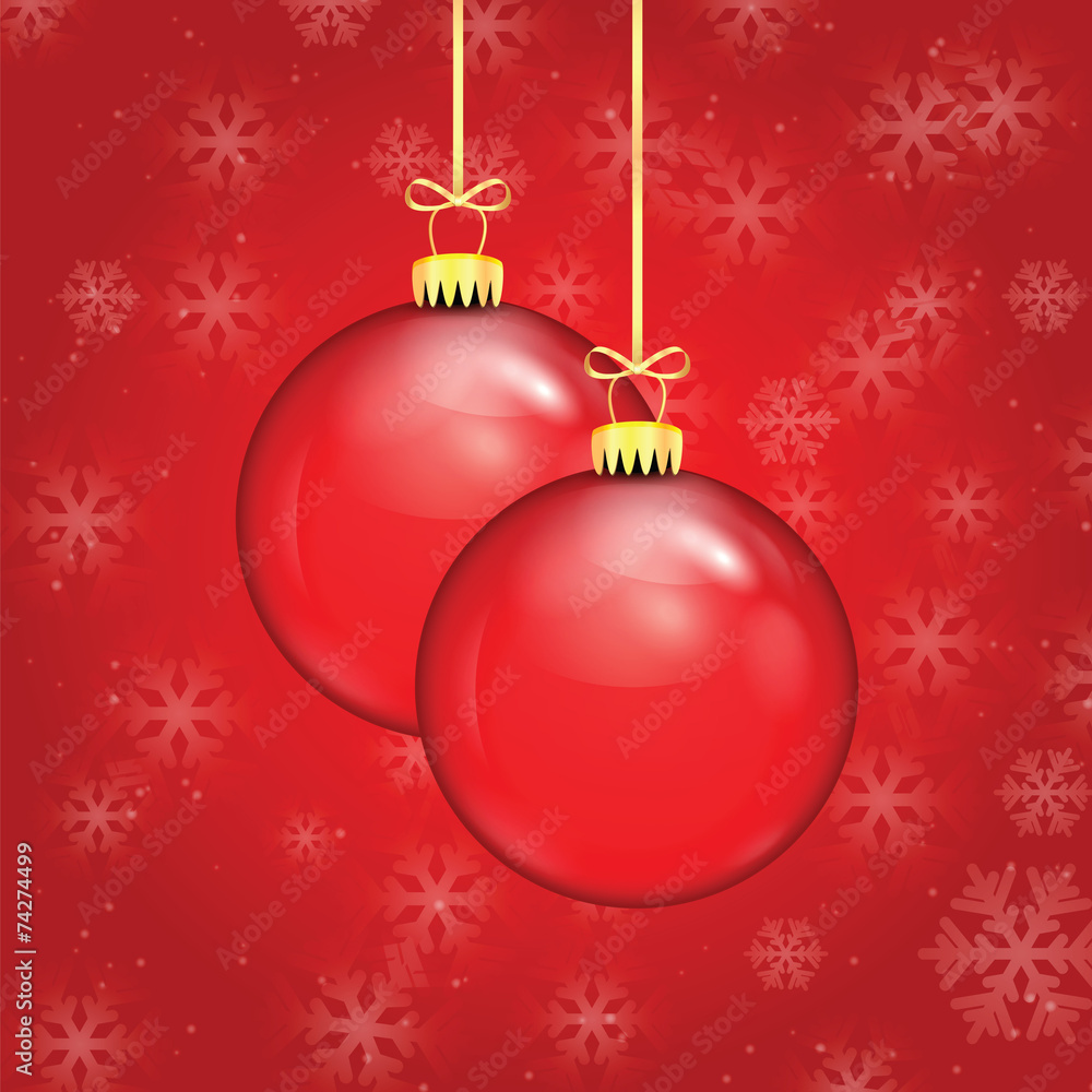 Red Christmas balls on a gold ribbon on a background of falling