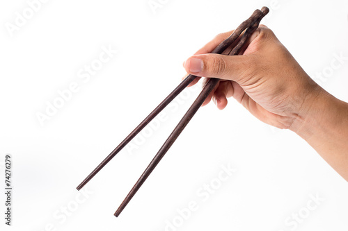 Handle Chopsticks held in a male hand on white background