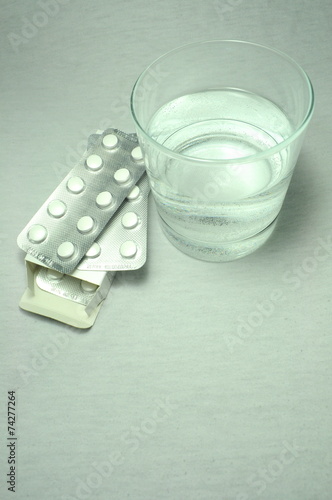 Glass of water and medicines