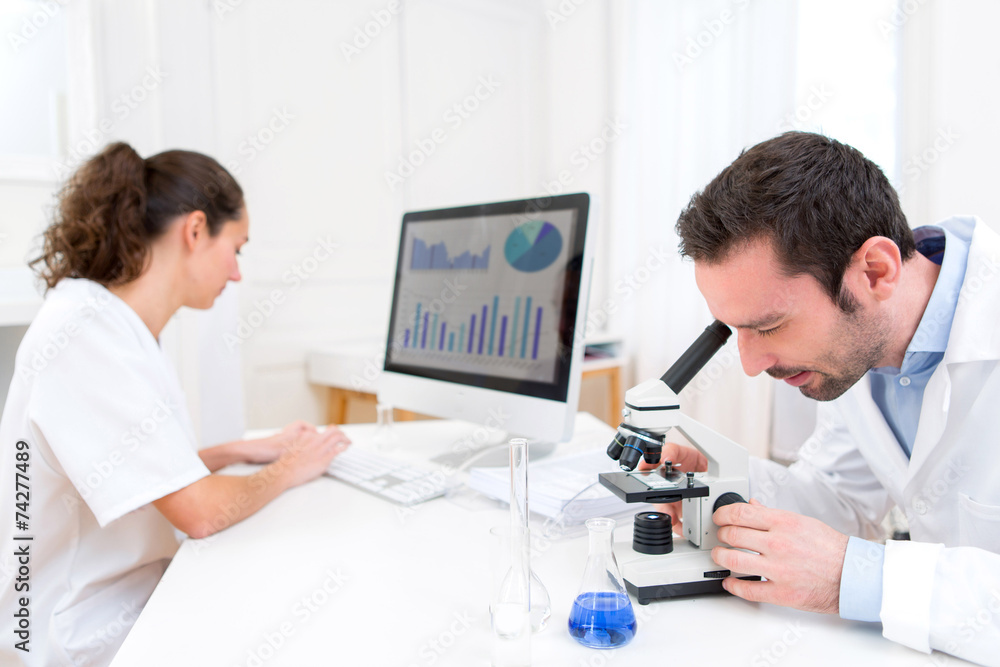 Scientist and her assistant in a laboratory Scientist and her assistant in a laboratory