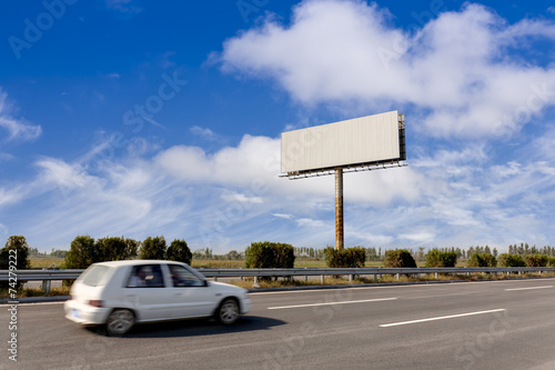 Blank billboard and blurred vehicle