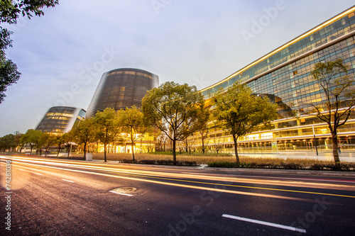 modern office building and traffic trails in urban city