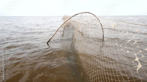 fishing net  a fish-trap on lake photo